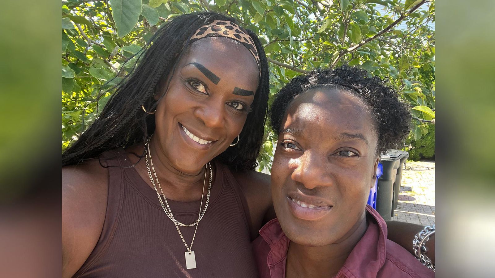 Stacy and her daughter are close together side by side and smiling