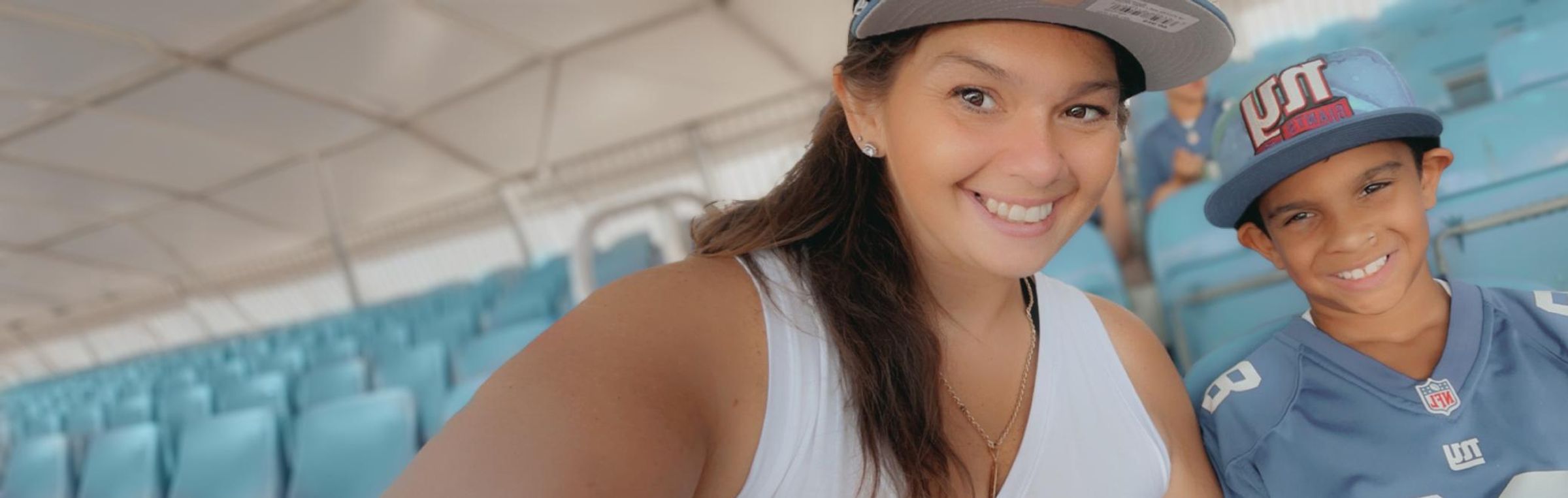 Mother and son smiling, leaning in together for a selfie