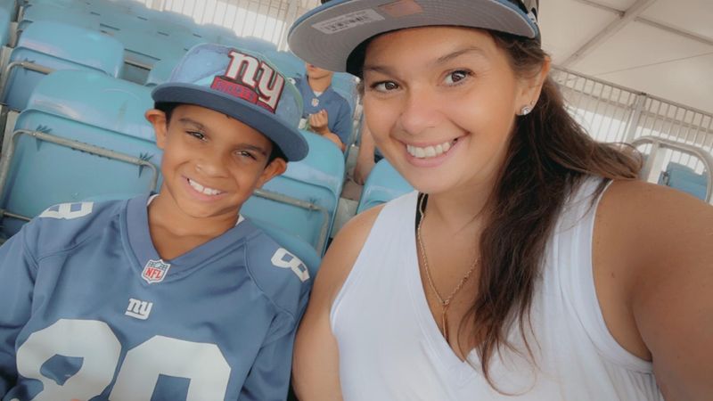 Mother and son smiling, leaning in together for a selfie