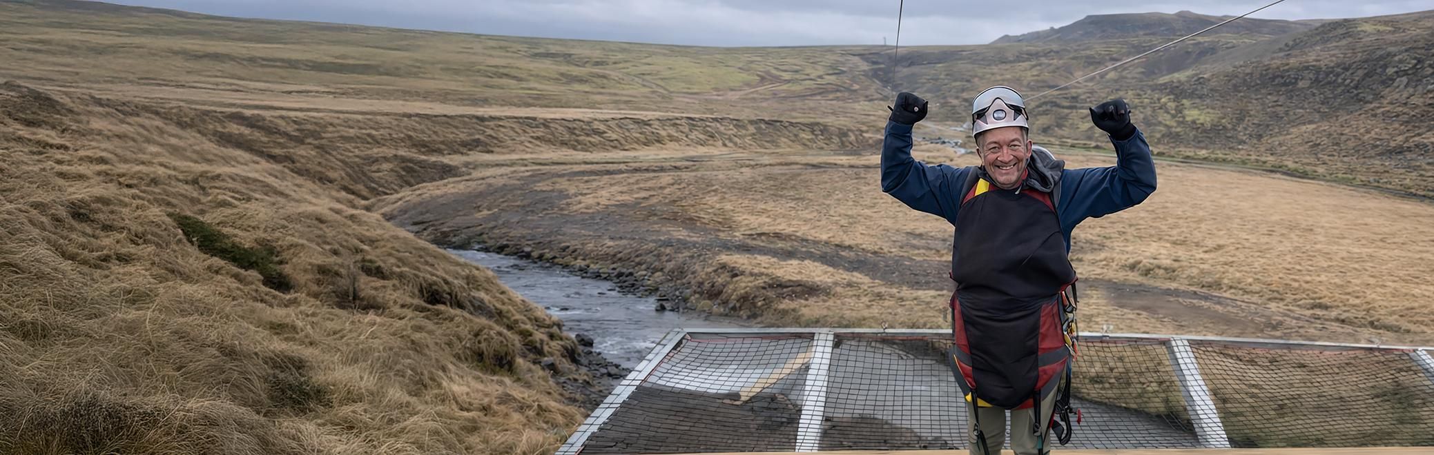Man smiling on a zipline adventure in Iceland