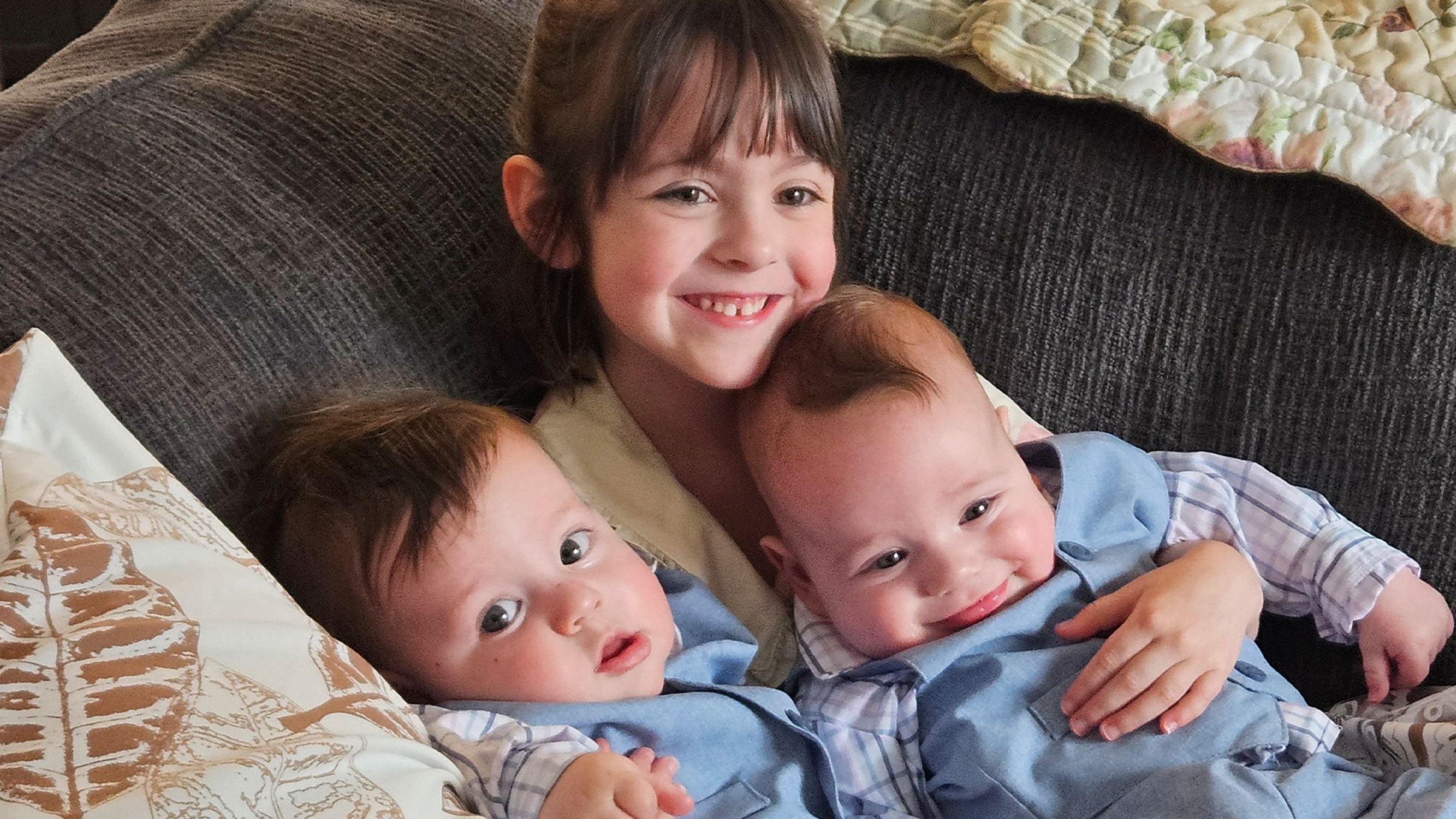 Three children smiling together
