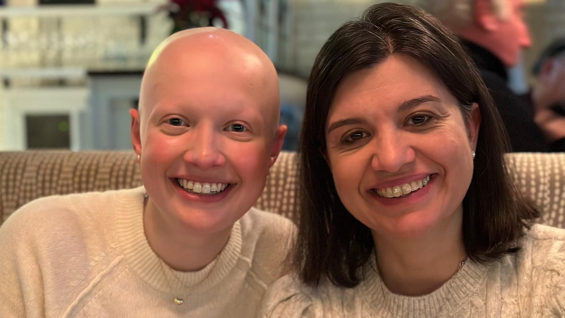 Debora Pellicano, Chief Financial Officer, North America & Head of Finance, Specialty Care (right), is seated at a restaurant booth next to her daughter (left)