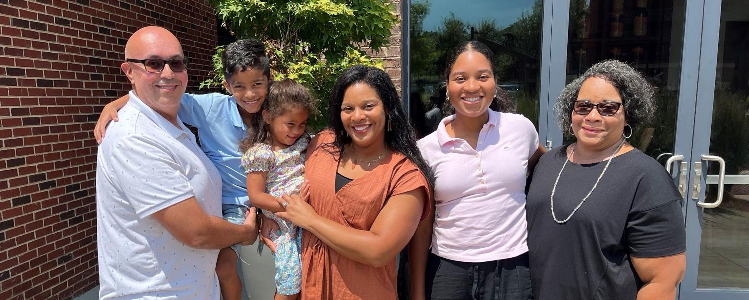 Dr. Ayanna Santos stands with her whole family.