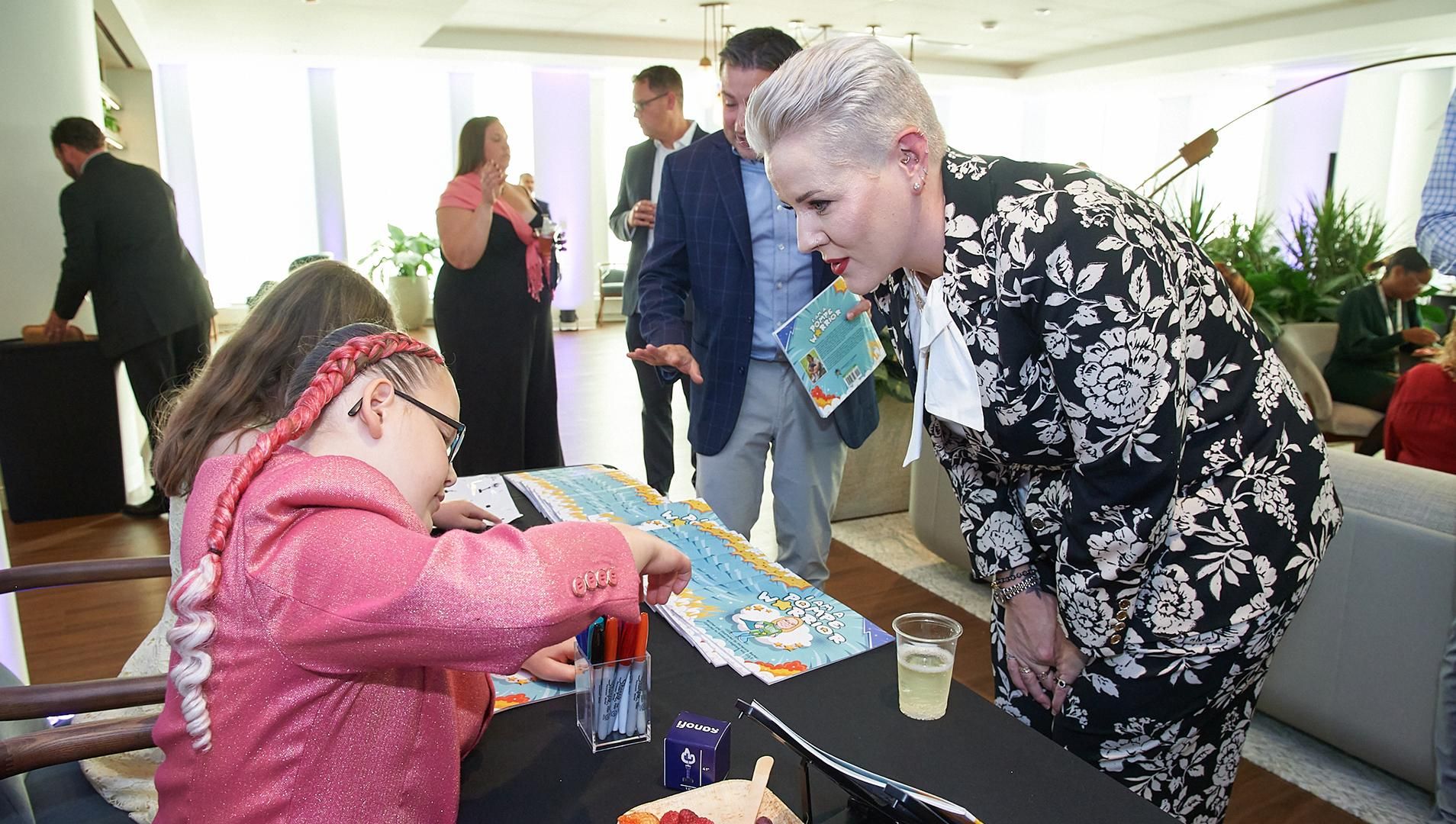 Interaction between attendee and child at the TORCH Awards event