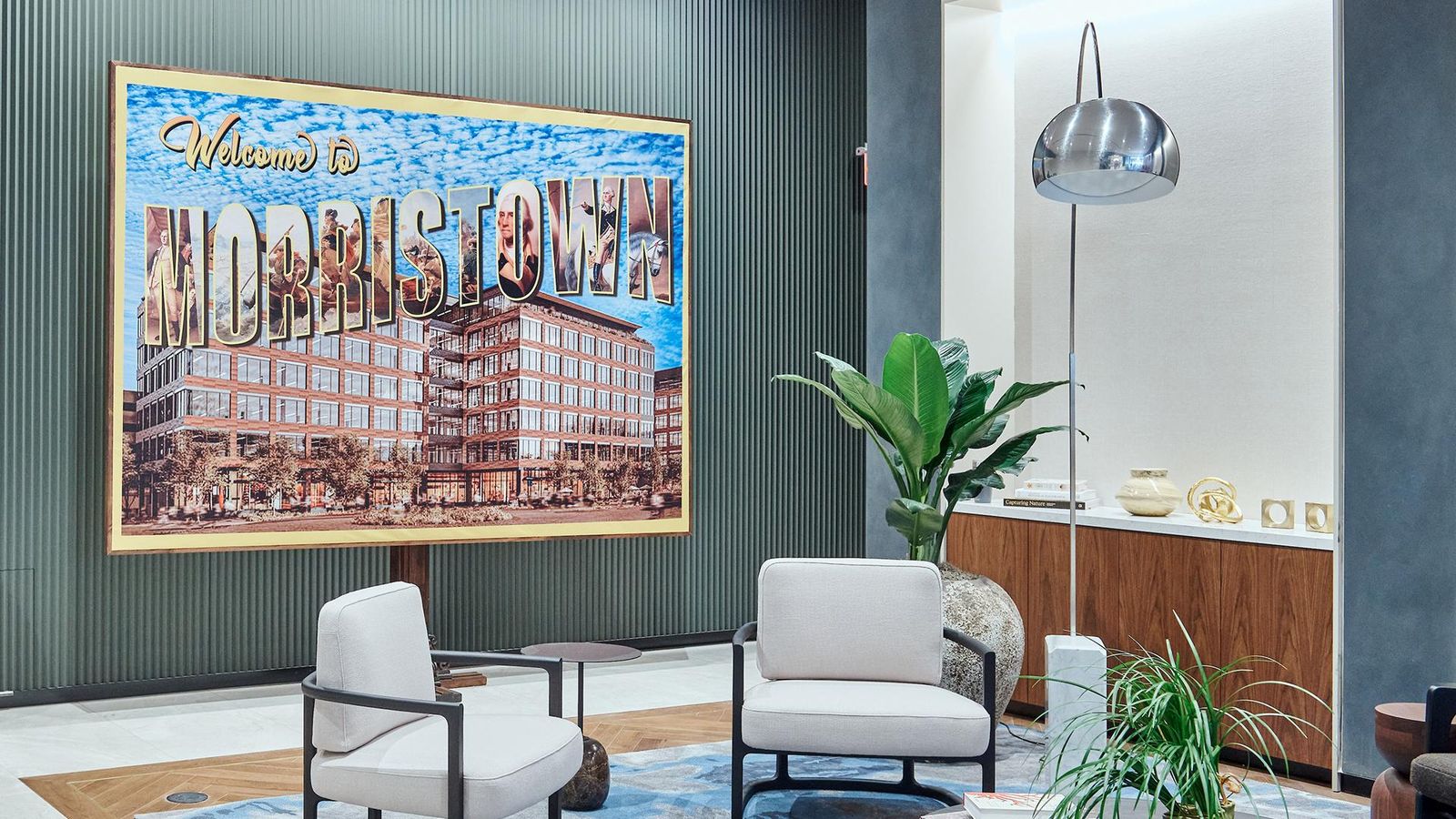 Interior shot of Sanofi’s Morristown site lobby featuring a “Welcome to Morristown” poster against a blue wall.